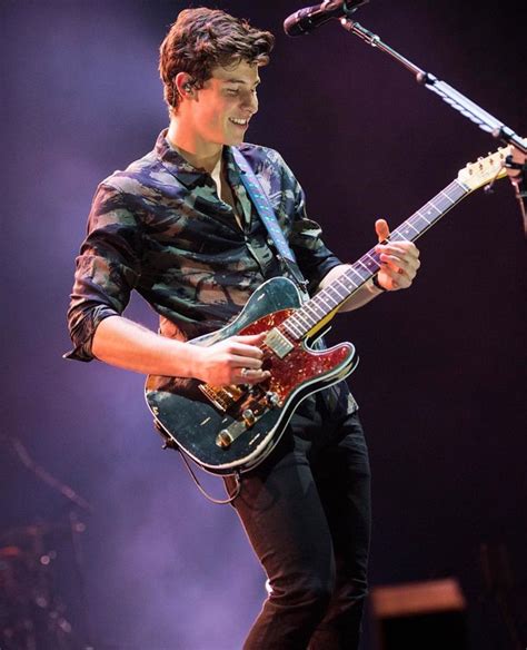 shawn mendes playing guitar.